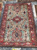 AN ORIENTAL RUG OF CAUCASIAN DESIGN, 180 x 123cms