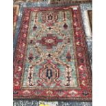 AN ORIENTAL RUG OF CAUCASIAN DESIGN, 180 x 123cms