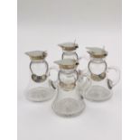 A SET OF FOUR SILVER AND GLASS WHISKY TOTS DATED 1924 BIRMINGHAM FOR HUKIN & HEATH LTD. TOGETHER