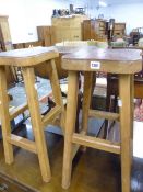 A PAIR OF VINTAGE STOOLS WITH TOOLED LEATHER TOPS.