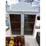 A TWO DOOR SMALL WALL DISPLAY CABINET