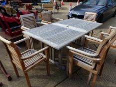 A GOOD QUALITY EXTENDING GARDEN TABLE AND TEN CHAIRS AND CUSHIONS. H. 76cms W. 110cms L. 190cms