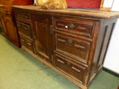 A 19th C. OAK DRESSER WITH BANKS OF THREE DRAWERS FLANKING THE CENTRAL CUPBOARD. W 173 x D 60 x H