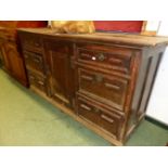 A 19th C. OAK DRESSER WITH BANKS OF THREE DRAWERS FLANKING THE CENTRAL CUPBOARD. W 173 x D 60 x H