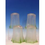 A SET OF FOUR ETCHED GLASS SHADES WITH GREEN TINTED HEXAFOIL RIMS. H 14cms.