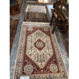 TWO ORIENTAL SMALL RUGS OF BOKHARA DESIGN TOGETHER WITH ANOTHER OF PERSIAN DESIGN, LARGEST 94 x