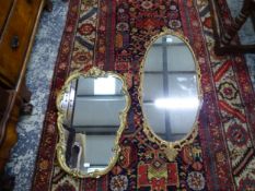 TWO GILT FRAMED WALL MIRRORS.