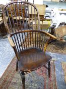 AN ANTIQUE WINDSOR CHAIR WITH NINE STICK BACK, SADDLE SEAT AND BALUSTER TURNED FRONT LEGS