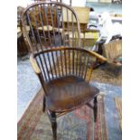 AN ANTIQUE WINDSOR CHAIR WITH NINE STICK BACK, SADDLE SEAT AND BALUSTER TURNED FRONT LEGS