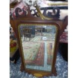 AN ANTIQUE FRET FRAMED WALL MIRROR.