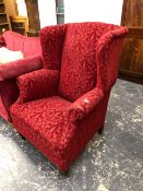 A WINGBACK ARM CHAIR.