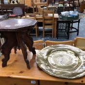 A SMALL CARVED EASTERN TABLE AND AN ENGRAVED EASTERN BRASS TRAY.