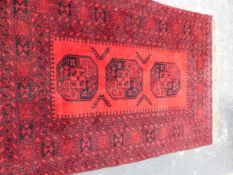 AN EASTERN RED GROUND RUG.