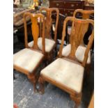A SET OF FOUR GEORGIAN ELM DINING CHAIRS ON CABRIOLE FORE LEGS.