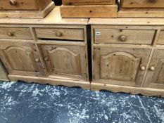 A PAIR OF SMALL PINE TWO DOOR CABINETS.