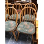 A SET OF FOUR ERCOL HOOP BACK DINING CHAIRS.
