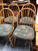 A SET OF FOUR ERCOL HOOP BACK DINING CHAIRS.