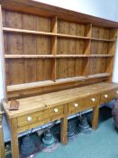AN EXTREMELY LARGE ANTIQUE PINE DRESSER WITH THREE DRAWER BASE.