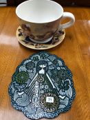 AN ORNAMENTAL TEACUP AND SAUCER PLANTER, AND A POTTERY POT STAND.