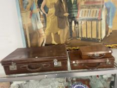 A LEATHER SUITCASE AND TWO ATTACHE CASES,