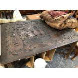 A LARGE ORIENTAL CARVED HARDWOOD PANEL NOW MOUNTED AS A TABLE ON FOLDING STAND.