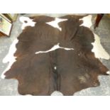 A COW HIDE RUG.