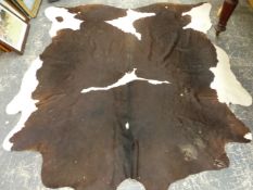 A COW HIDE RUG.