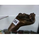 A GENESIS 2000 LIMITED EDITION BRONZED FIGURE OF A CHILD ASLEEP IN A HAND
