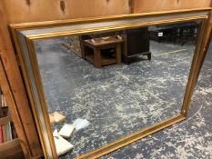 A LARGE GILT FRAMED MIRROR.