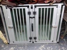 AN ALUMINIUM DOUBLE DOG TRANSPORT CAGE.