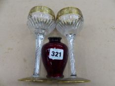 AN EARLY 20th C. JAPANESE RED ENAMELLED VASE TOGETHER WITH A PAIR OF STUART GILT GLASS WINES.