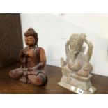 A CARVED HARDWOOD BUDDHA TOGETHER WITH A CARVED STONE FIGURE OF GANESH.