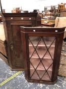 A GEORGIAN GLAZED CORNER CABINET AND A PANEL DOOR CORNER CABINET.