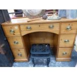 AN ANTIQUE PINE KNEE HOLE DRESSING TABLE.