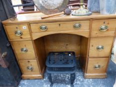 AN ANTIQUE PINE KNEE HOLE DRESSING TABLE.