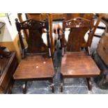A PAIR OF VICTORIAN OAK HALL CHAIRS.