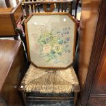 A VINTAGE RUSH SEAT LOW CHAIR AND A NEEDLE POINT PANEL.