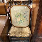 A VINTAGE RUSH SEAT LOW CHAIR AND A NEEDLE POINT PANEL.