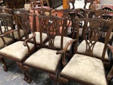 A SET OF SIX GEORGIAN STYLE DINING CHAIRS WITH CARVED PIERCED BACKS.