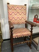 A HENRY II STYLE WALNUT ARMCHAIR WITH UPHOLSTERED SEAT AND BACK.