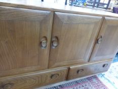 AN ERCOL PALE ELM SIDE BOARD.