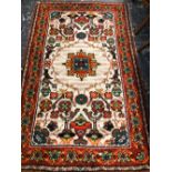 A SMALL WOOL HOOKED RUG.
