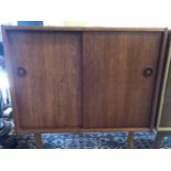 A SMALL TEAK SIDE CABINET.