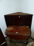 AN OAK CORNER CABINET AND AN OCCASIONAL TABLE.