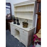 A CREAM PAINTED PINE DRESSER, THE ENCLOSED TWO SHELF BACK ABOVE A BASE WITH THREE DRAWERS OVER TWO