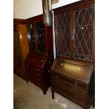 AN EDWARDIAN MAHOGANY BUREAU BOOKCASE AND A LATER OAK EXAMPLE.