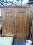 A 20th C. PINE WARDROBE WITH THE TWO DOORS OVER TWO DRAWERS AND THE PLINTH FOOT. W 164 x D 57 x H