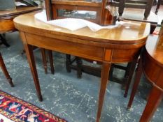 A GEORGE III MAHOGANY DEMILUNE GAMES TABLE WITH LINE INLAID APRON AND TAPERING SQUARE LEGS ON