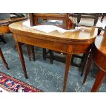 A GEORGE III MAHOGANY DEMILUNE GAMES TABLE WITH LINE INLAID APRON AND TAPERING SQUARE LEGS ON