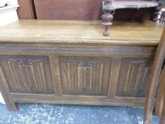 A 20th C. OAK COFFER, THE THREE PANELLED FRONT CARVED WITH LINEN FOLD. W 105 x D 46 x H 51cms.